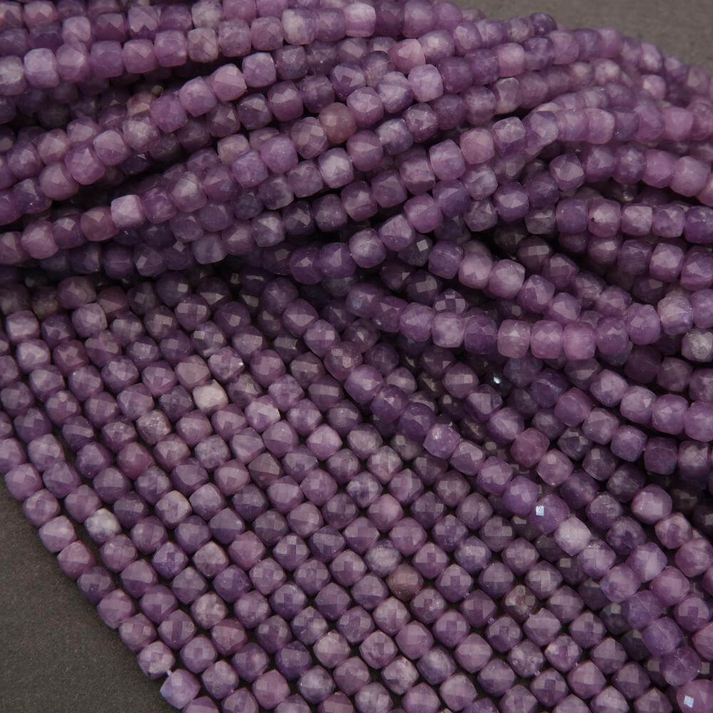 Close-up of purple beads on a dark background