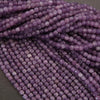 Close-up of purple beads on a dark background