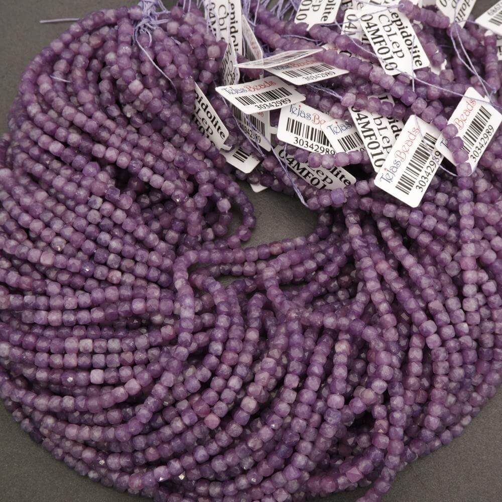 Purple beads with price tags on a gray surface