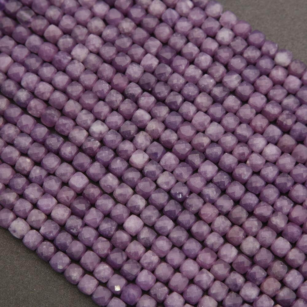 Close-up of purple beads on a gray background