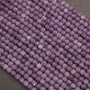 Close-up of purple beads on a gray background