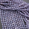 Close-up of purple beads on a gray background