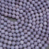 Close-up of purple beads on a dark background