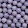Close-up of purple beads on a dark background
