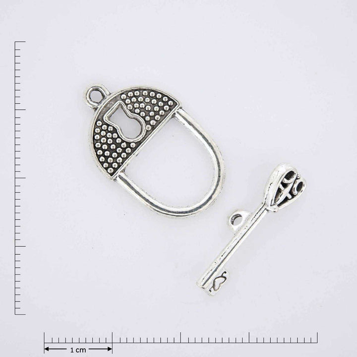 Silver lock and key clasp closure.