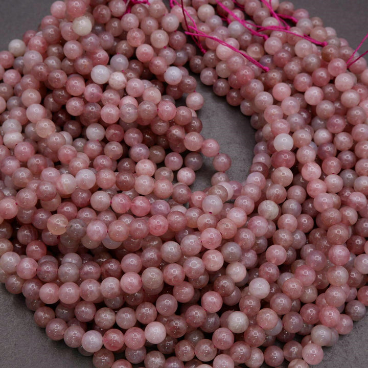 String of pink beads on a gray surface