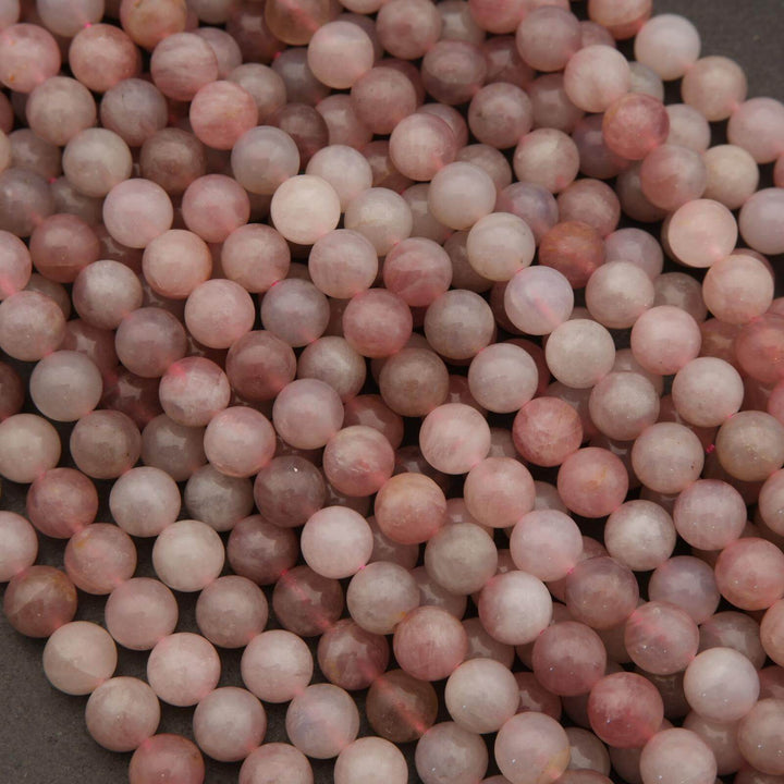 Close-up of pink beads on a dark surface