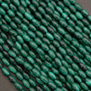 Close-up of green beads on a dark background