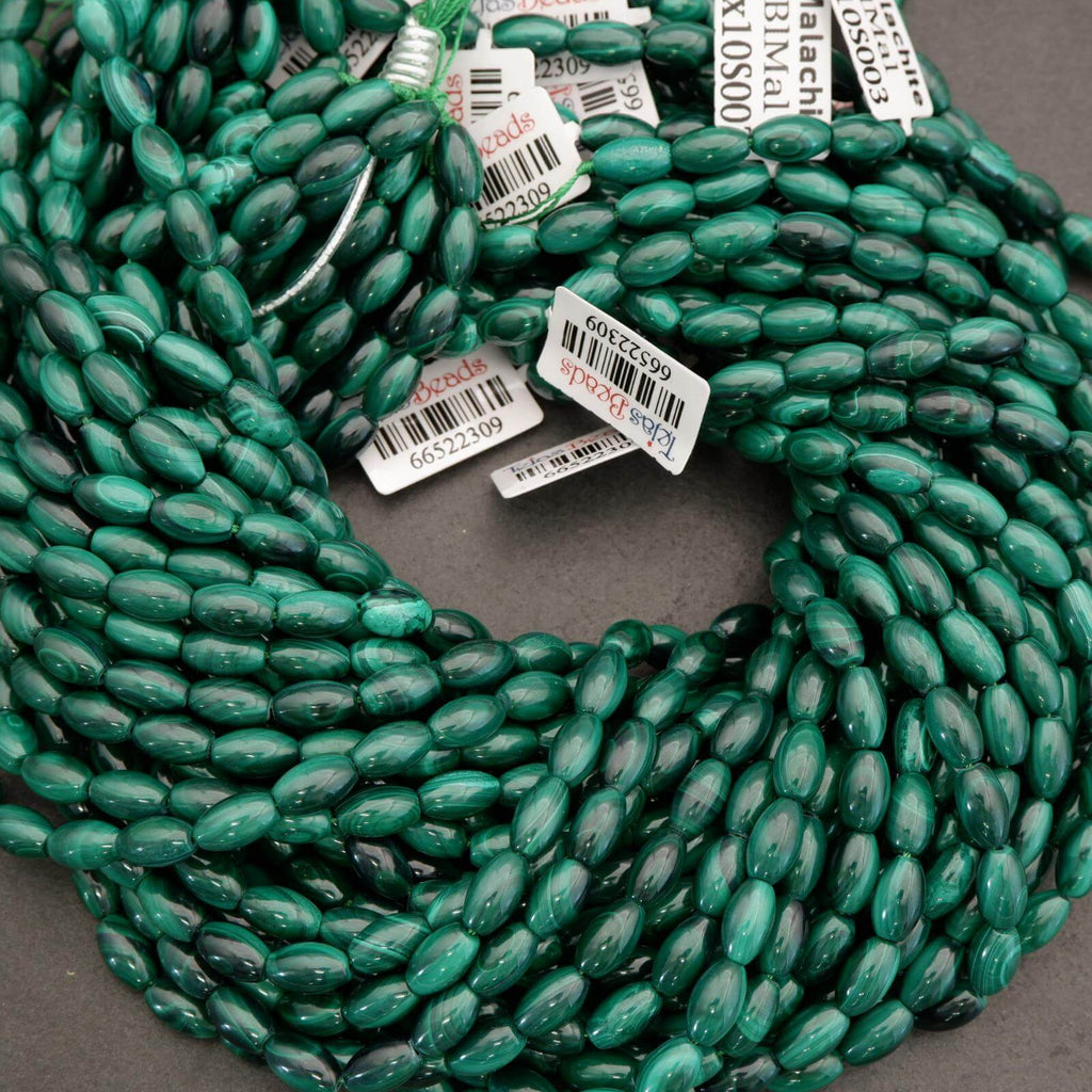 Green beads on a string with barcodes attached, on a gray background