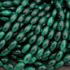 Close-up of green oval beads on a dark background