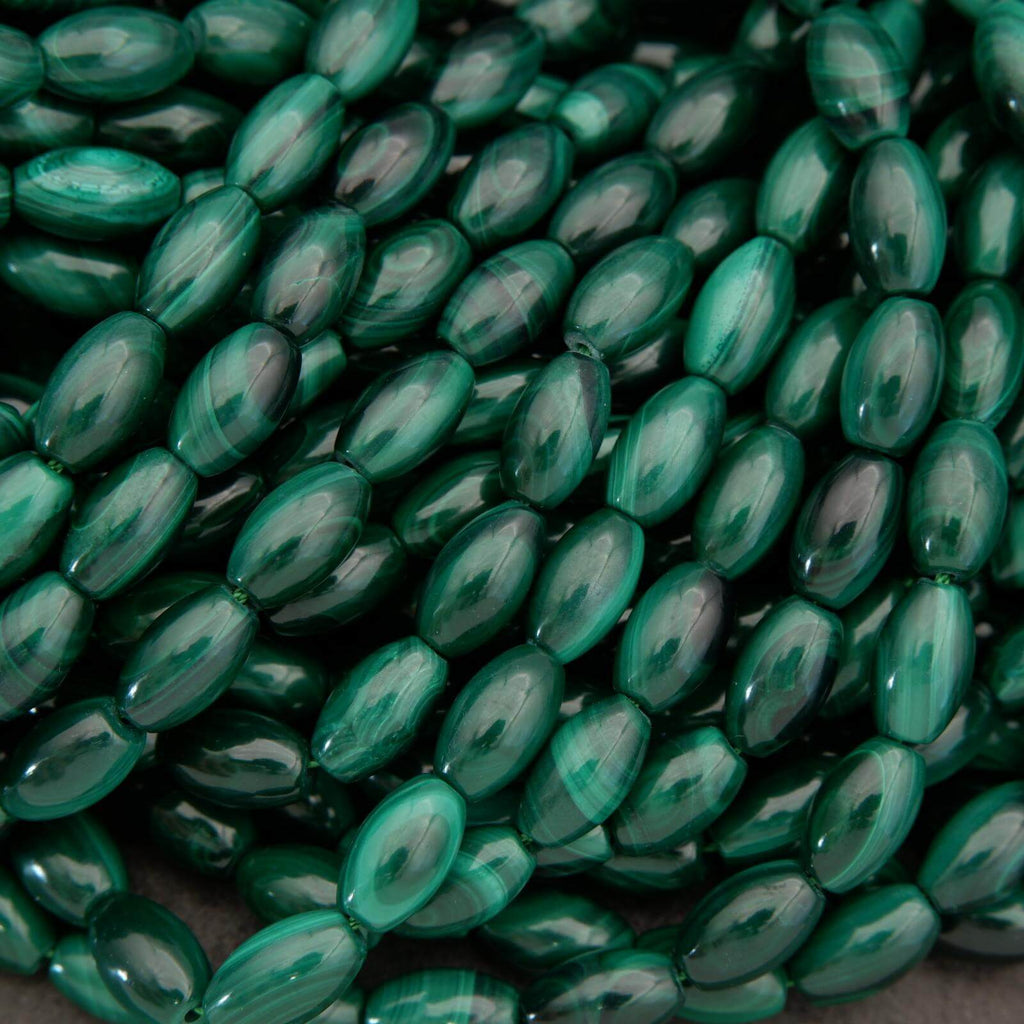 Close-up of green oval beads on a dark background