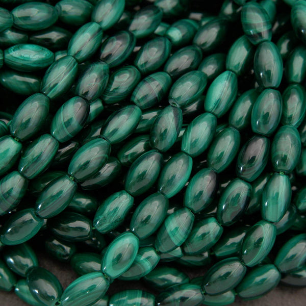 Close-up of green oval beads on a dark background