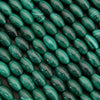 Close-up of green oval beads on a dark background
