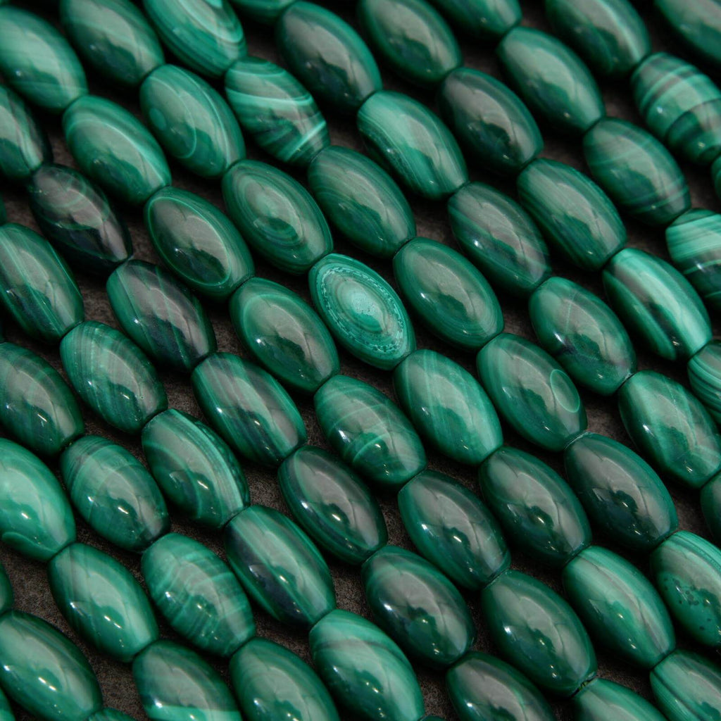 Close-up of green oval beads on a dark background