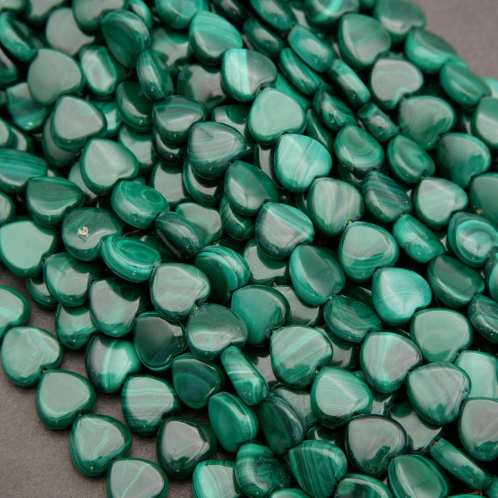 Green heart-shaped beads on a gray surface
