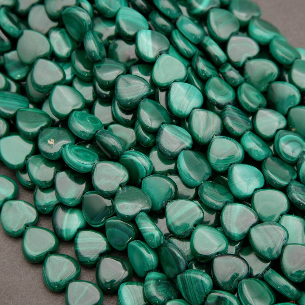 Green heart-shaped beads on a gray surface