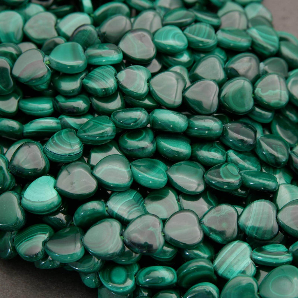 Close-up of green heart-shaped beads on a dark background