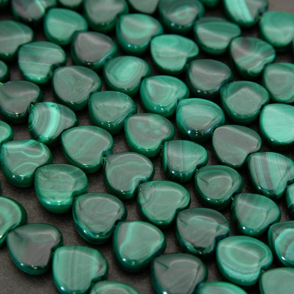 Green heart-shaped beads on a dark background