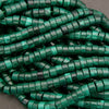 Close-up of green plastic zip ties on a gray background