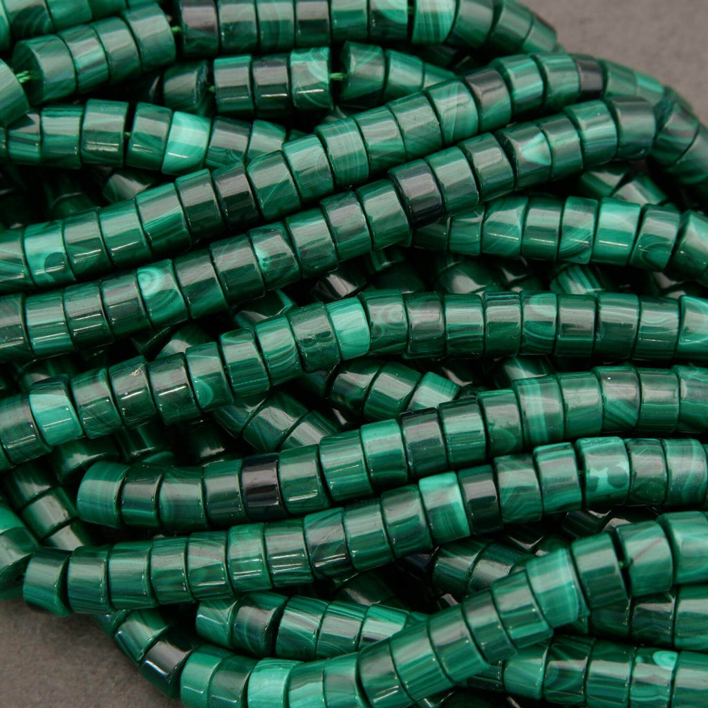 Close-up of green plastic zip ties on a gray background
