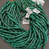 Green plastic coils with labels on a gray background