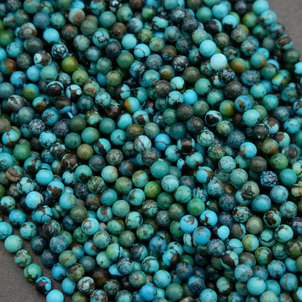 Turquoise and green beads scattered on a surface
