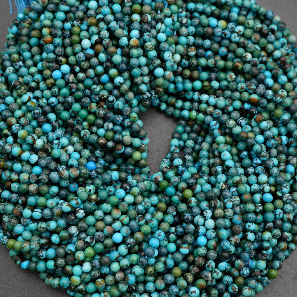 String of turquoise beads on a gray background