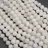 Close-up of white ceramic beads on a dark background