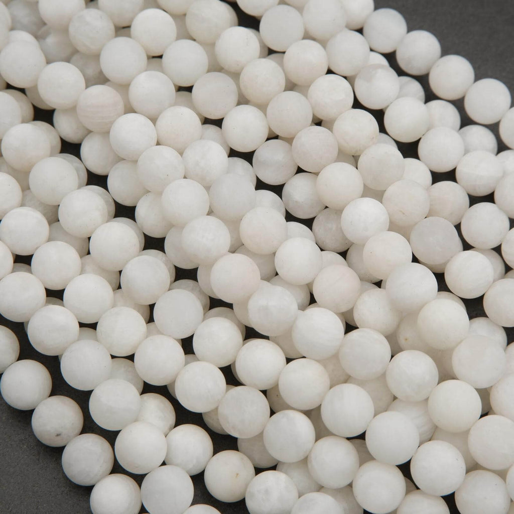 Close-up of white ceramic beads on a dark background
