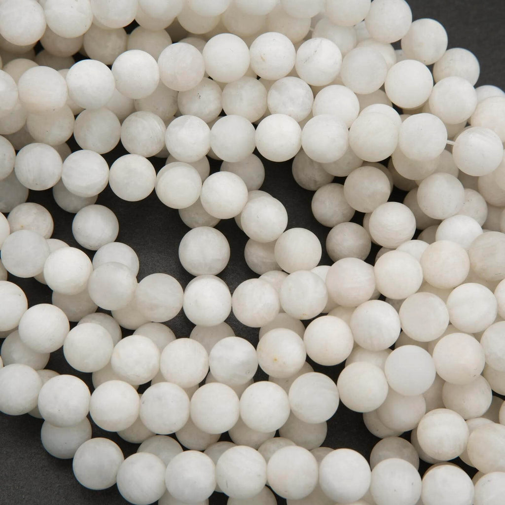 Close-up of white spherical beads on a dark background