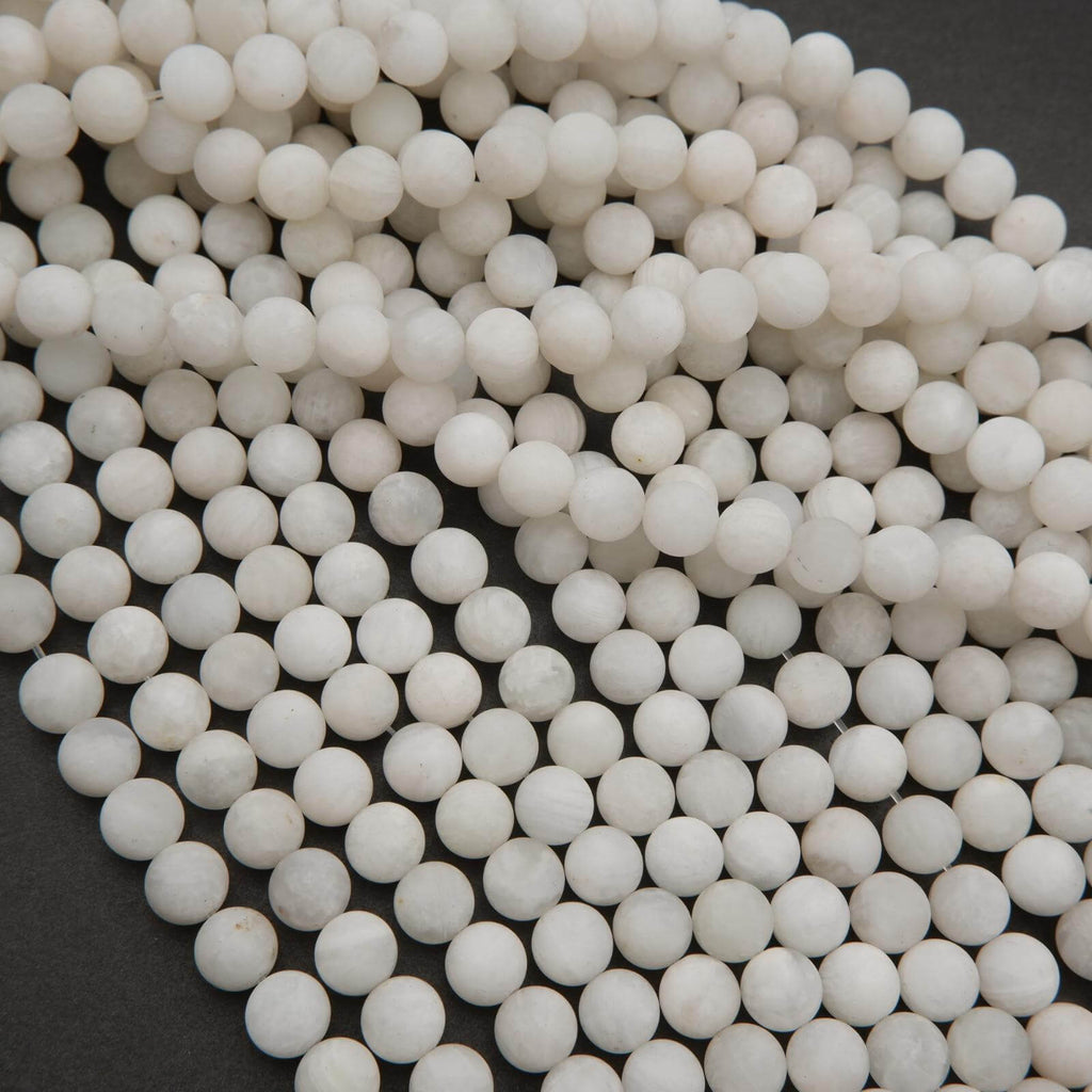 Close-up of white spherical beads on a dark background