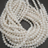 String of white beads on a dark background