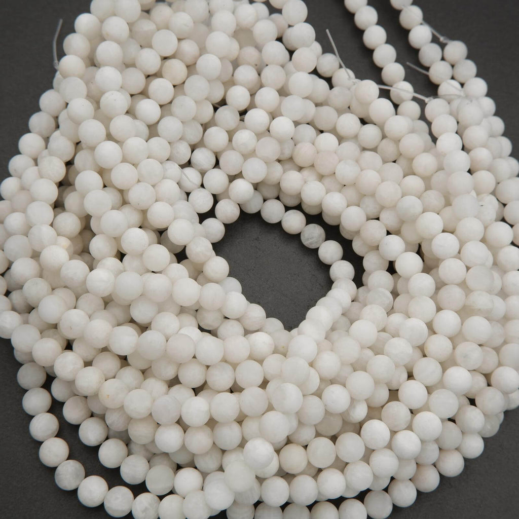 String of white beads on a dark background