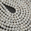 Close-up of white spherical beads on a black background