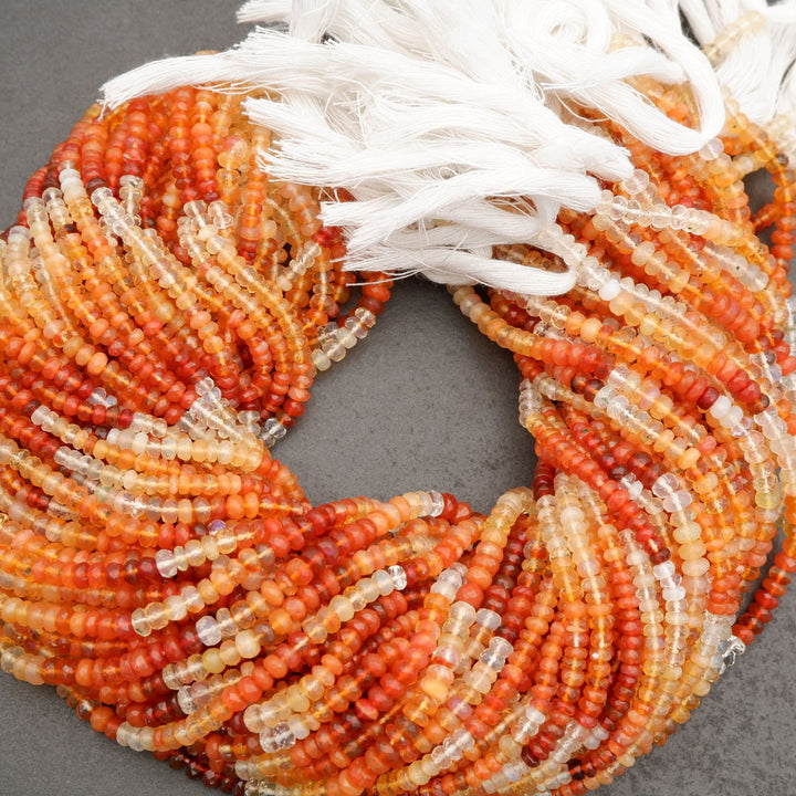Close-up of a beaded wreath with orange, white, and beige beads on a gray background