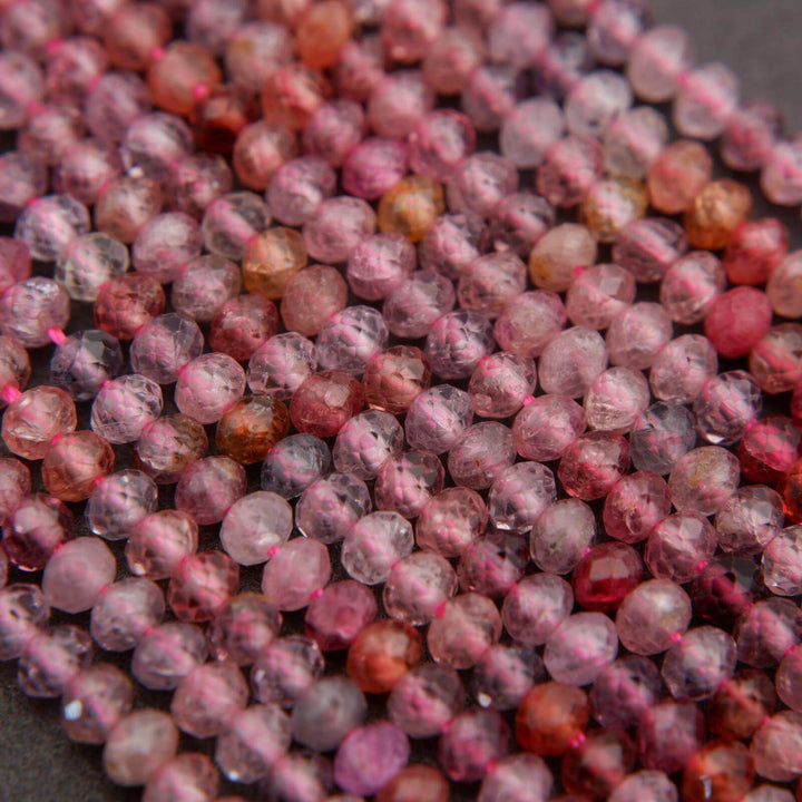 Close-up of pink and red beads on a dark background