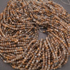 Close-up of a string of brown and gray beads on a gray background