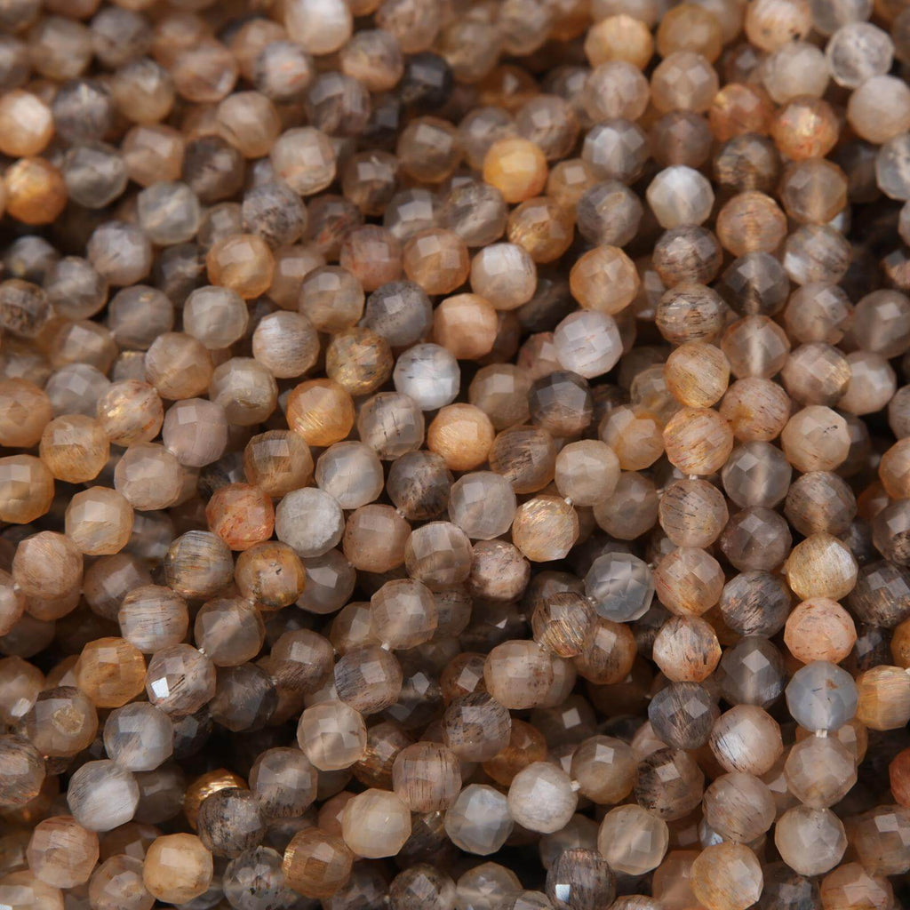 Close-up of small, faceted gemstones in various shades of brown and gray.