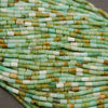 Close-up of a string of green and white beads.