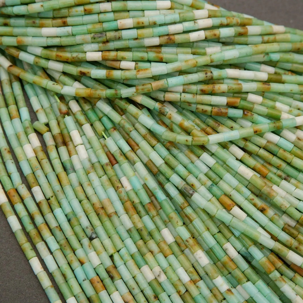 Close-up of green and white cylindrical beads.