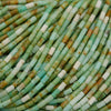 Close-up of green and brown cylindrical beads.