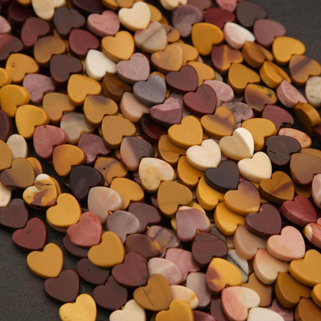 Close-up of a pile of multicolored heart-shaped objects on a dark background
