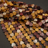 Heart-shaped beads in various colors on a dark surface