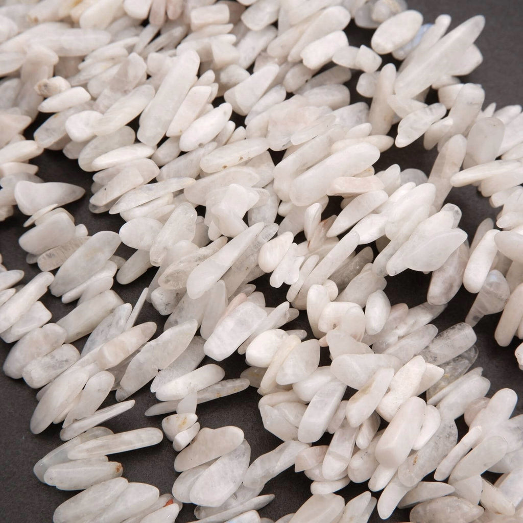 Close-up of white pebbles on a dark surface