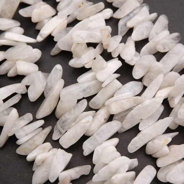 Close-up of white pebbles on a dark surface