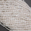 Close-up of a string of small, clear beads on a dark background