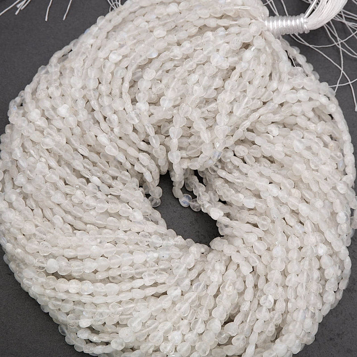 Close-up of a string of white beads on a dark surface