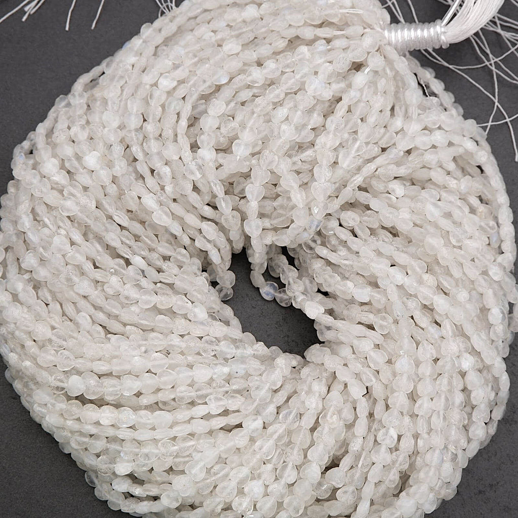 Close-up of a string of white beads on a dark surface