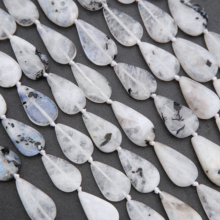 Teardrop-shaped beads on a dark surface