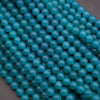 Close-up of turquoise beads on a dark background